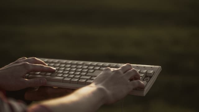 A person typing on a laptop