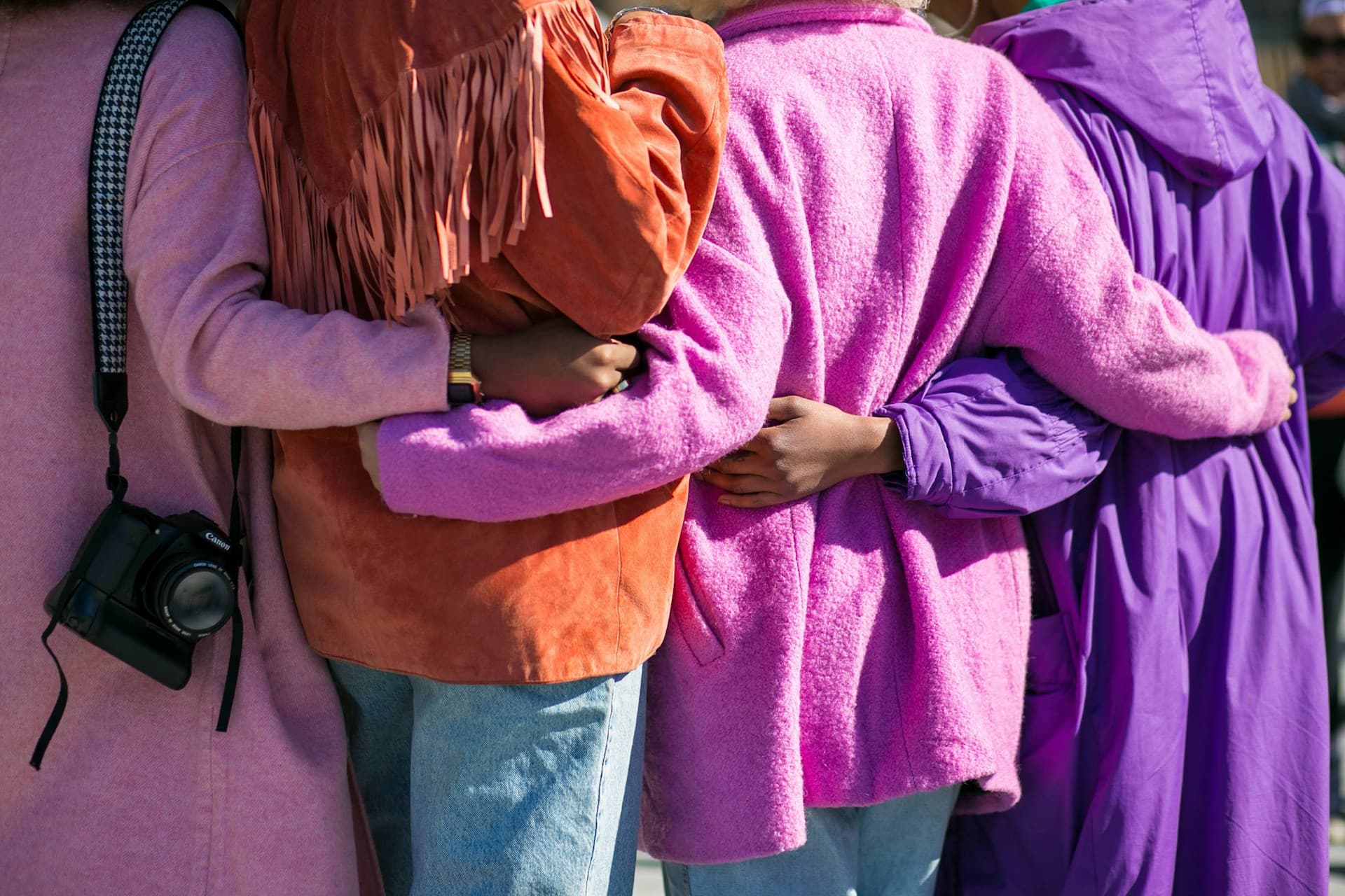 Image of people holding each other